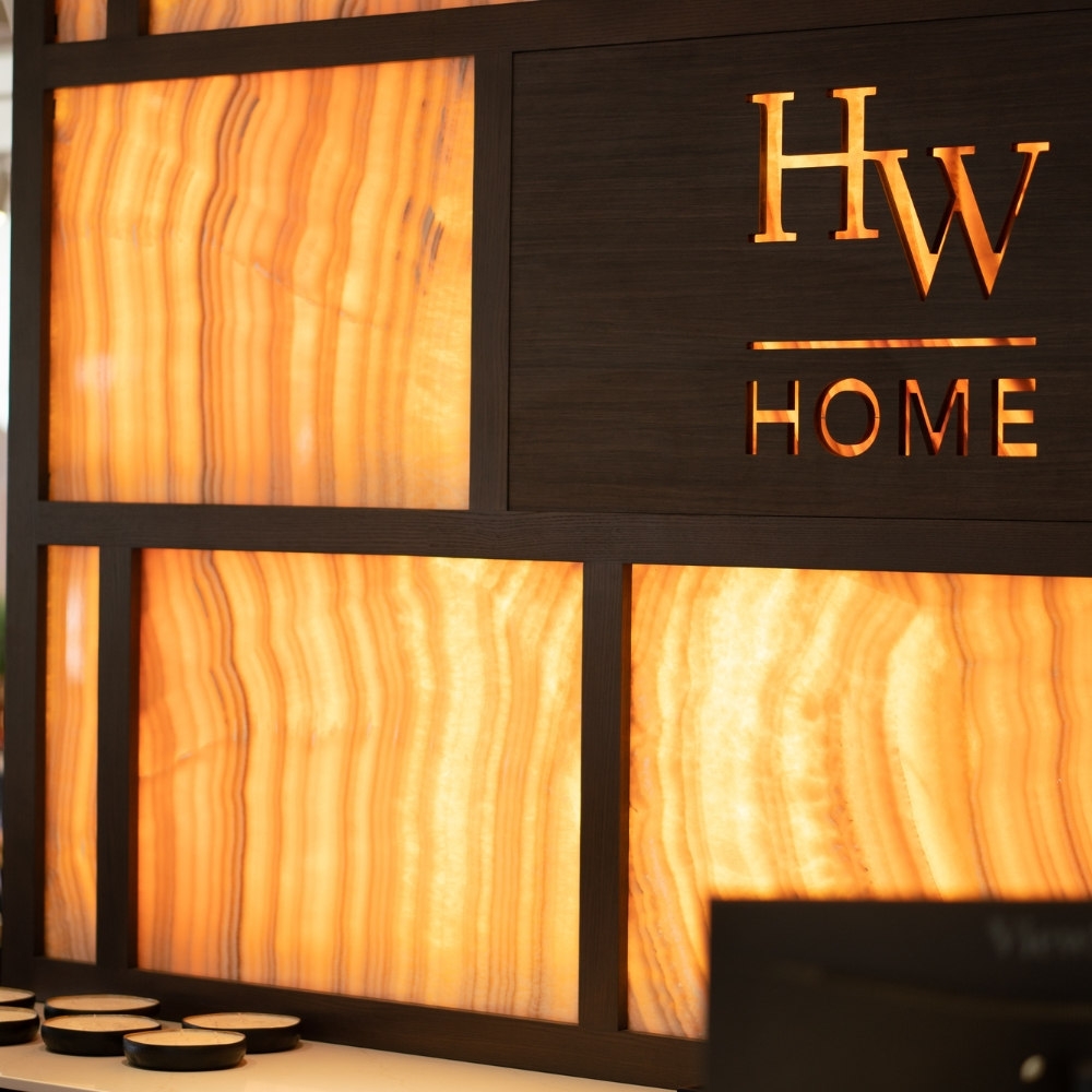 Illuminated onyx-and-walnut feature wall at the new HW Home flagship
